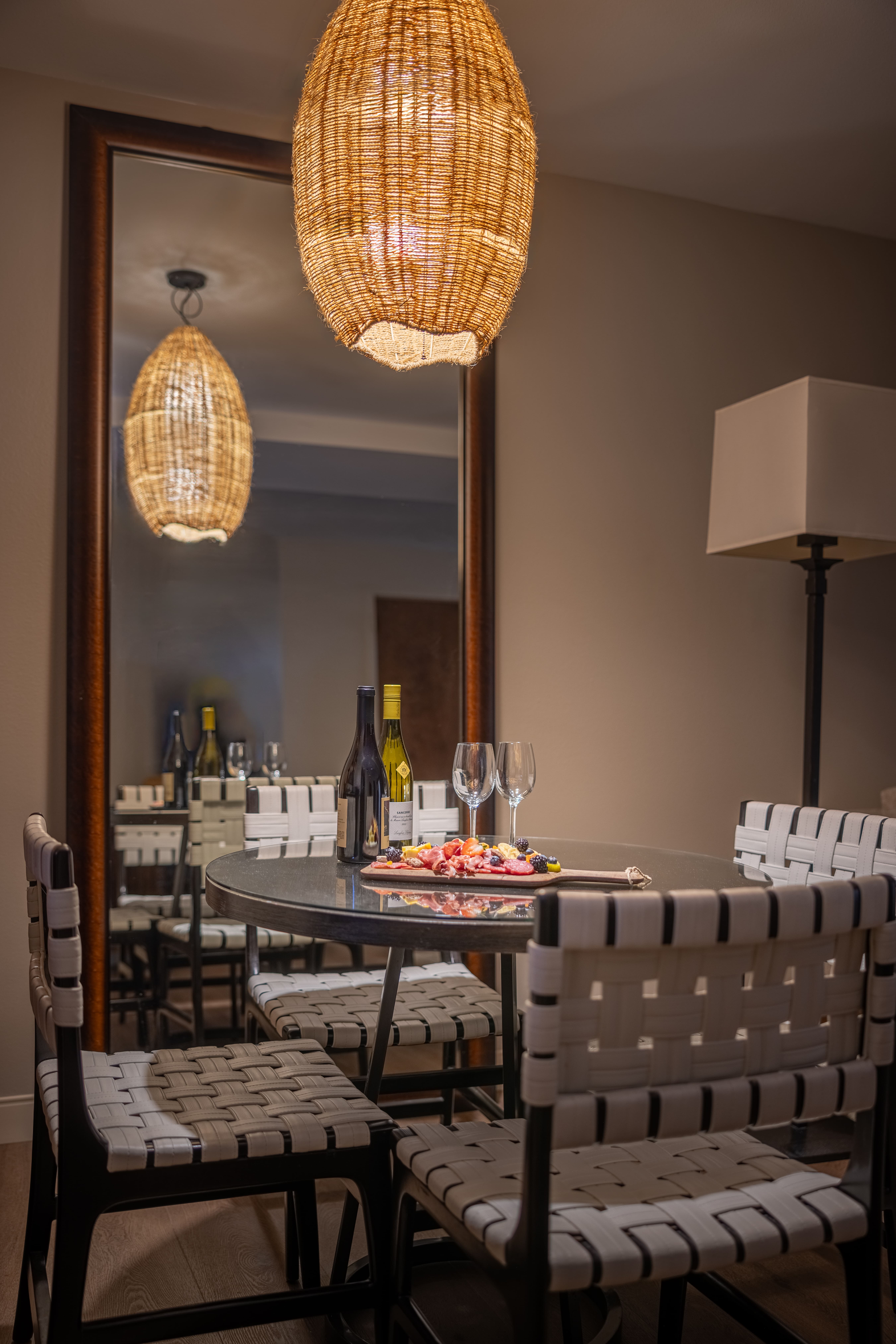 A dining area with a table set for wine and charcuterie.